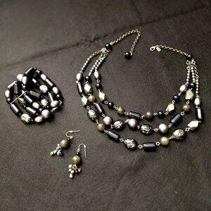 Three-strand necklace,, with matching bracelet and earrings.
